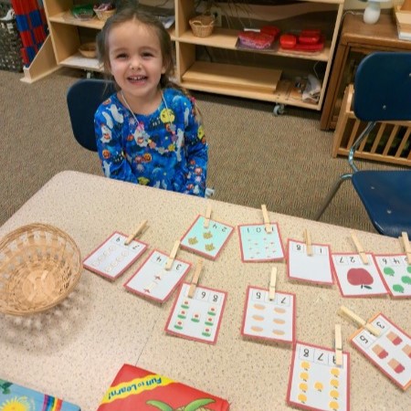 A young student enjoying the benefits of Montessori learning.